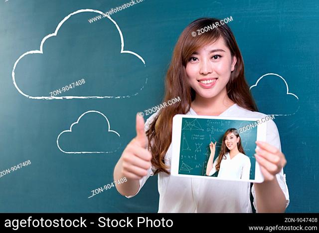 beautiful asian girl teacher with tablet and green blackboard