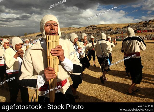 Indigenous people with traditional costumes during a performance with their pan flutes at the Inti Raymi Festival in Saqsaywaman Archaeological Site, Cusco