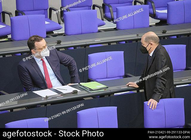 21 April 2021, Berlin: Jens Spahn (CDU), Federal Minister of Health, speaks with Olaf Scholz (SPD), Federal Minister of Finance, in the Bundestag session