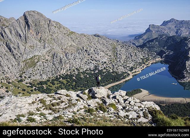 hiker watching Gorg Blau reservoir, Escorca, Mallorca, Balearic Islands, Spain