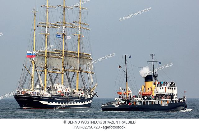 The Russian sailing ship 'Kruzenshtern' and the ice breaker 'Stettin' (r) can be seen during the squadron parade of the 26th Hanse Sail on the Baltic Sea in...