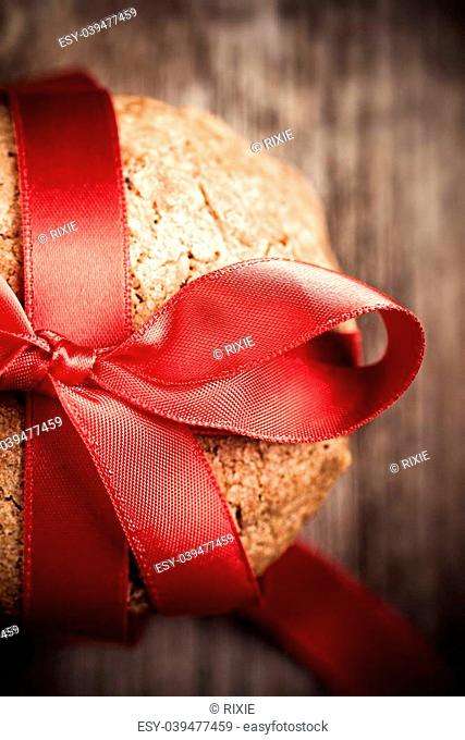 A stack of home made cookies tied with a red ribbon, a gift for Santa or a loved one. Top view closeup with retro style processing
