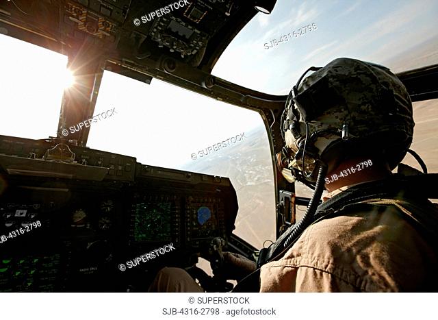 A U.S. Marine Corps aviator in the cockpit of an MV-22 Osprey during a combat operation in southern Afghanistan's Helmand Province