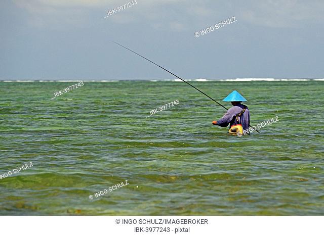 Fisherman standing in the water, Sanur, Bali, Indonesia