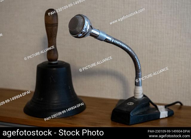 28 December 2022, Hessen, Laisa: A microphone and a bell stand on a cabinet of the village radio system. In the Laisa district of Battenberg (Eder) in the...