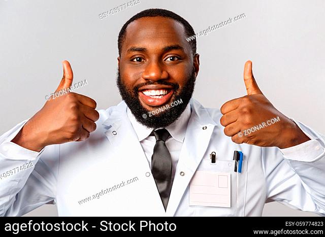 Healthcare, medicine and hospital treatment concept. Close-up portrait of satisfied, happy african-american doctor, physician assure patient do check-up this...