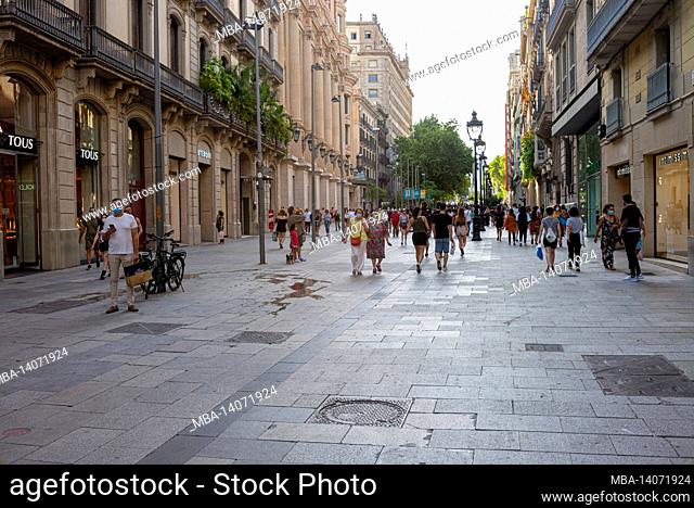 tourists walk famous la rambla street in barcelona, spain. the most popular street in barcelona