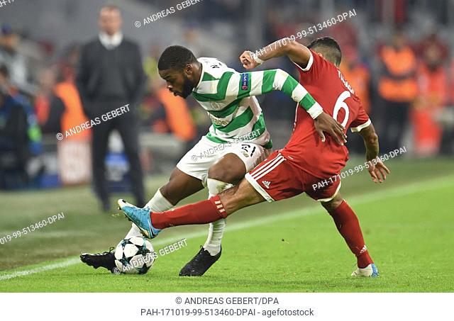 Munich's Thiago Alcantara and Glasgow's Olivier Ntcham (L) vie for the ball during the Champions League group stage match between FC Bayern Munich and Celtic...