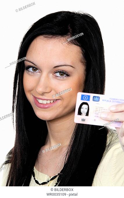 Woman with car keys and drivers license. Driving test