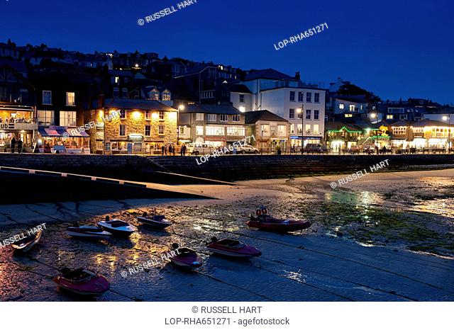 A view of bars and restaurants along the shore in St Ives at night