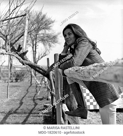 Brazilian actress Florinda Bolkan, Florinda Soares Bulcão's stage name, is in riding clothes and leans against a fence at Tor di Quinto riding stables; after...