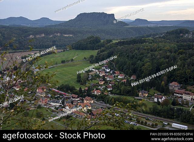 03 October 2020, Saxony, Bastei: View from the Bastei bridge with the spa town of Rathen and the 415-metre-high Lilienstein