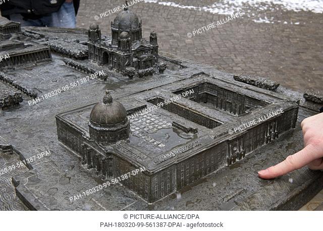 20 March 2018, Germany, Berlin: A woman touches the expanded tactile model of the Museumsinsel (lit. museum island) by sculptor Egbert Broerken at the...