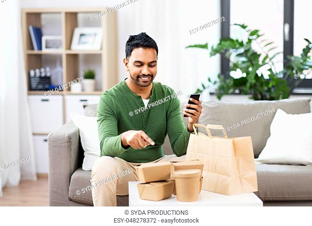 indian man using smartphone for food delivery