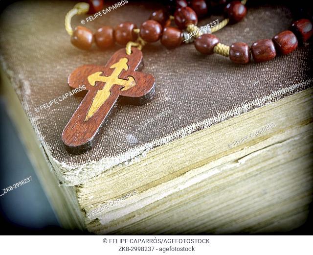 An ancient rosary on an old book