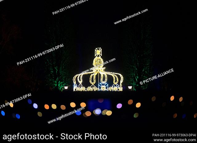 16 November 2023, Saxony, Dresden: A crown and the pleasure garden are illuminated to mark the opening of the ""Christmas Garden"" light show in the grounds of...