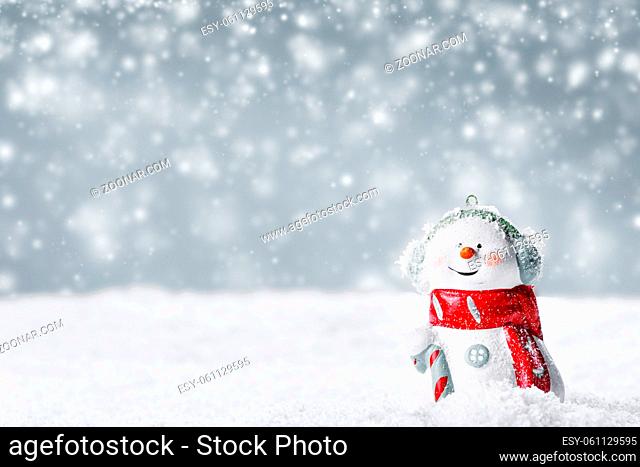 Christmas Snowman toy on winter background in the snow