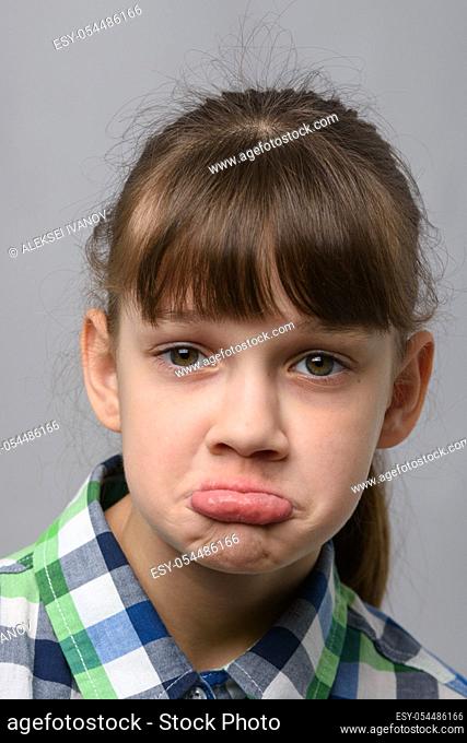 Portrait of a displeased ten-year-old girl of European appearance, close-up