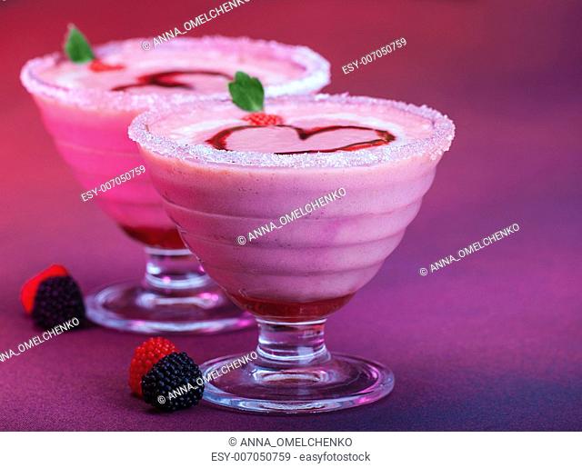 Image of romantic dessert with red heart shape on the top, Valentine day party, creamy milk beverage, smoothie with fresh fruits on purple background