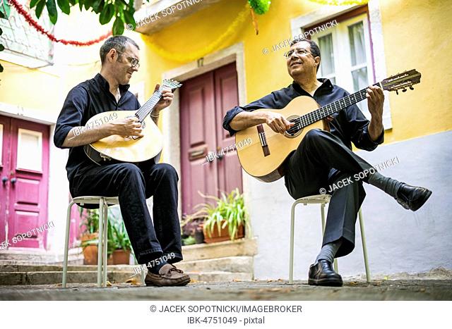 Two fado guitarists with acoustic and portuguese guitars in Alfama, Lisbon, Portugal