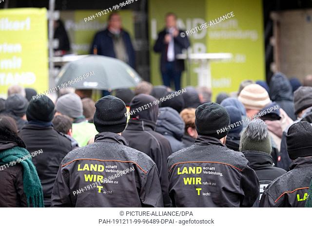 11 December 2019, Rhineland-Palatinate, Mainz: Farmers listen to a speaker at a rally. Farmers demonstrate with several hundred tractors in the state capital