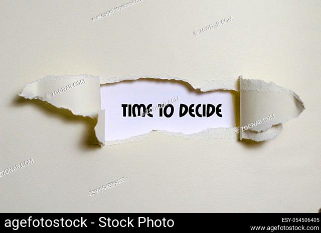 The word time to decide appearing behind torn paper