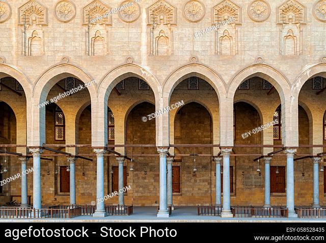 Arched corridor surrounding the courtyard of public ancient mosque of Sultan Al Moaayad, Old Cairo, Egypt