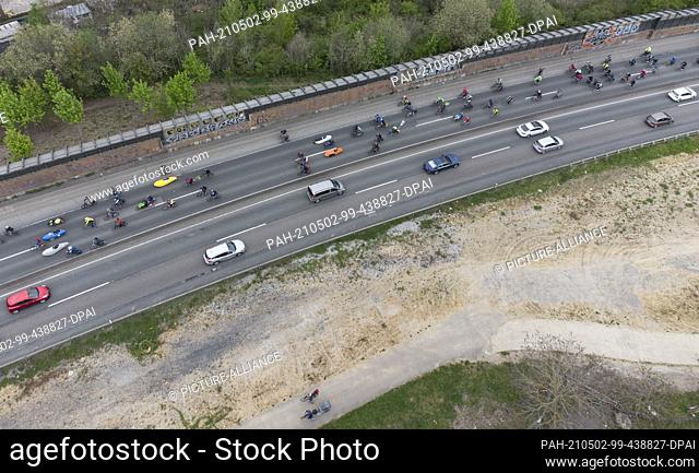 02 May 2021, Hessen, Frankfurt/Main: Cyclists protesting for climate change and transport reforms ride their bikes along the A-661 to Frankfurt (aerial photo...