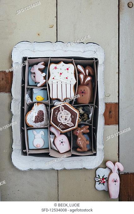 An Easter cookie box filled with royal icing cookies like Easter rabbits