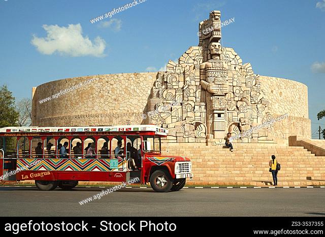Touristic bus and tourists in front of the Monument to the Fatherland by Romulo Rozo Pena at Paseo Montejo in the city center, Merida, Yucatan State, Mexico