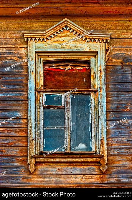 Wooden window of ild house with carved frame of wooden lacy in Astrakhan Russia