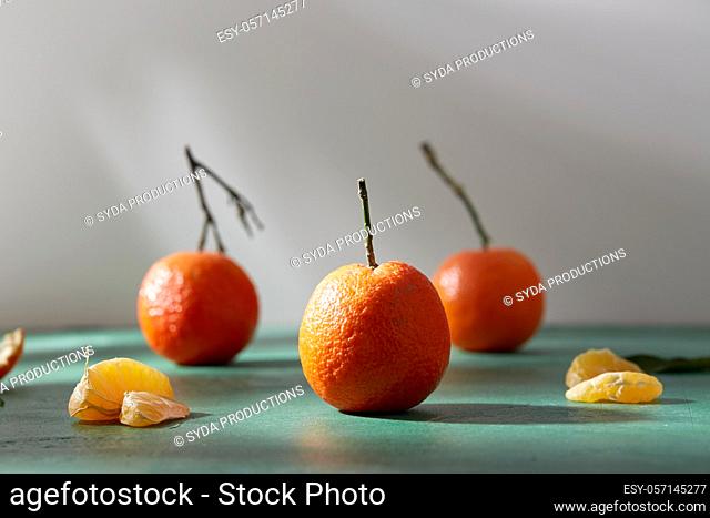 still life with mandarins on green background
