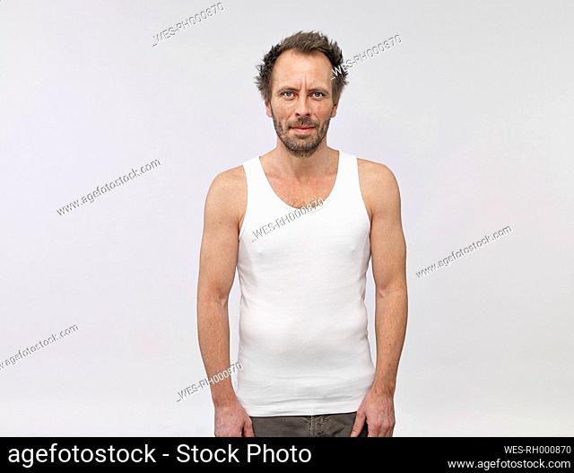 Portrait of man wearing white vest