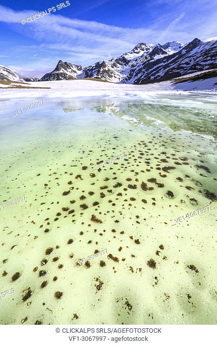 Turquoise water of Lake Andossi during thaw, Chiavenna Valley, Spluga Valley, Sondrio province, Valtellina, Lombardy, Italy