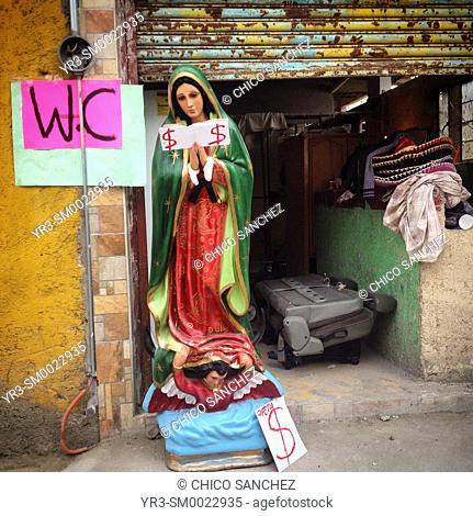 A sculpture of the Virgin of Guadalupe decorates the entrance of a WC during the annual pilgrimage to the Basilica of Our Lady of Guadalupe in Mexico City
