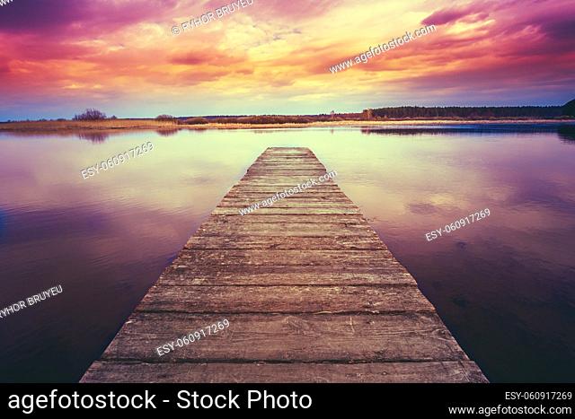 Old Wooden Pier. Calm River Nature Background. Toned Instant Filtered Photo Image