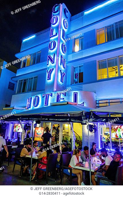 Florida, Miami Beach, Ocean Drive, Art Deco Historic District, Colony Hotel, restaurant, sidewalk cafe, alfresco, dining, evening, night, nightlife, neon sign