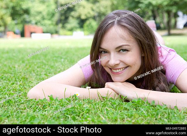 Woman is lying in a meadow