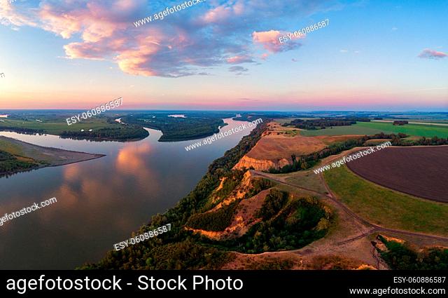 Aerial drone view of river landscape in sunny summer evening. Top view of siberian Ob river from high attitude in summer sunset