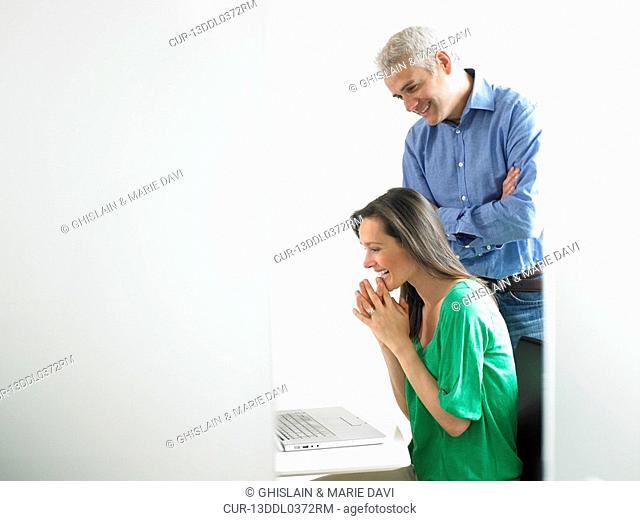 Woman working on computer with colleague