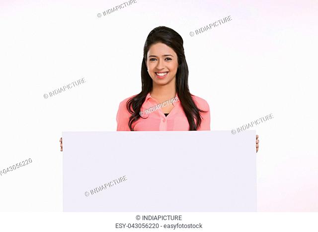 Portrait of girl holding white board