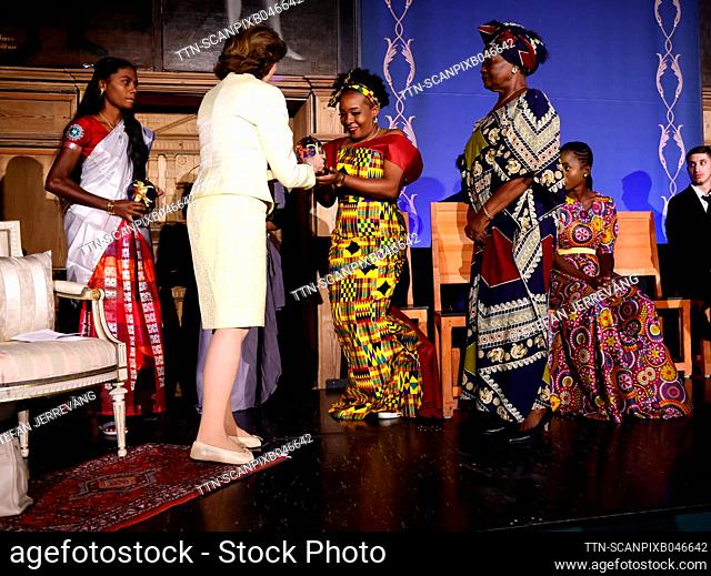Sweden's Queen Silvia awards glass globes to Florence Mutake (yellow dress) of the organisationen Shamwari Ye Mwanasikana, SYS, in Zimbabwe