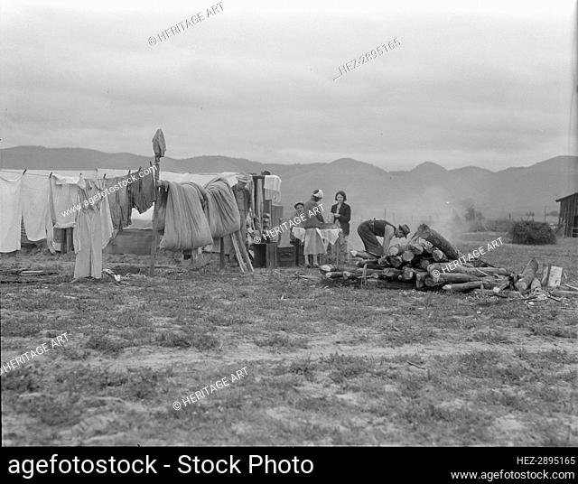 Arkansas family washing dishes, seven months in California, 1936. Creator: Dorothea Lange