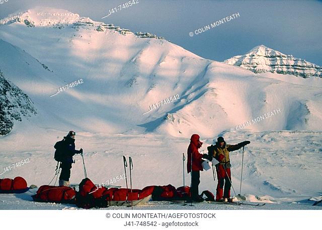 Ski tourers with sledges on spring ski traverse Ny Alesund to Longyearbyen Spitsbergen Island Svalbard Norwegian Arctic