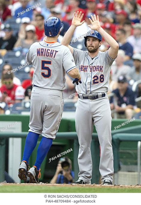 New York Mets second baseman Damiel Murphy (28) and third baseman David Wright (5) congratulate one another after scoring the first two runs in the first inning...