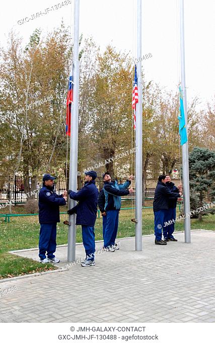 Outside their Cosmonaut Hotel crew quarters in Baikonur, Kazakhstan, the Expedition 30 prime and backup crews conducted the traditional flag-raising ceremony on...