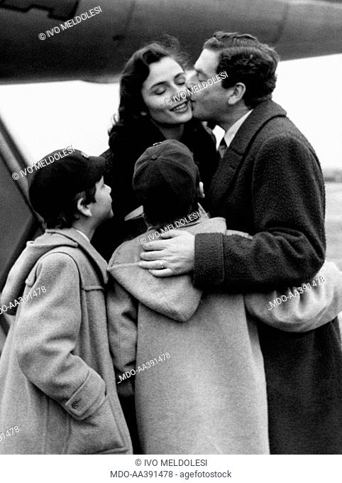 Claudio Gora kissing Marina Berti. Italian actor Claudio Gora (Emilio Giordana) kissing Italian actress Marina Berti (Elena Maureen Bertolino) on her cheek