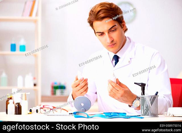 Young male doctor otolaryngologist working at the hospital