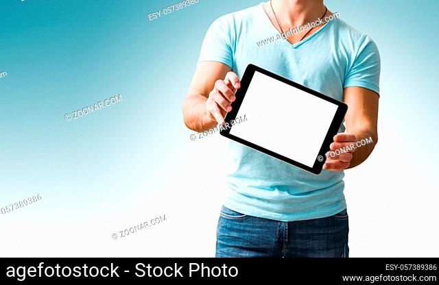 Casual man showing digital tablet computer screen in hands. Isolated on white. Clipping path for display included