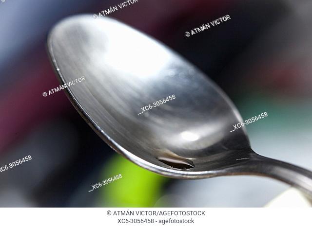 stainless steel tea spoon on a blurred multicolour background